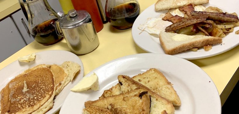 Bigman Breakfast. This picture shows three separate platters that consists of Pancakes, eggs, Bacon, sausage, and home fries on Johnys counter.