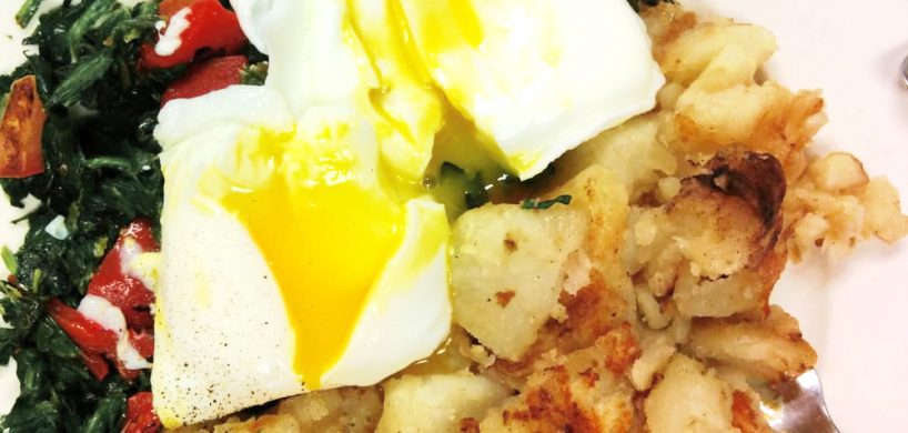 Emmas Eggs. This picture depicts two poached eggs on top of a bed of sautéed spinach and roasted peppers with an additional water of home fries accompanied on the side for an extra charge, served on a weekly