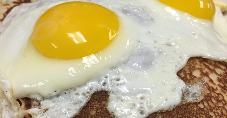 Lumber Jack. This picture consists of pancakes with two sunny side up eggs, yet the lumberjack also includes Bacon