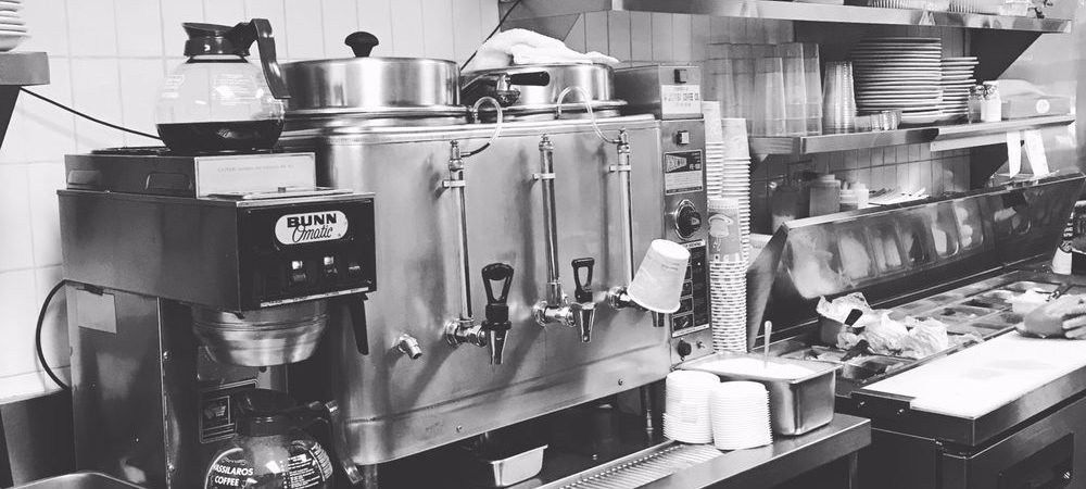 This picture to pics Johny’s’s coffee machine and coffee station in a black-and-white photo which expresses the originality of this establishment
