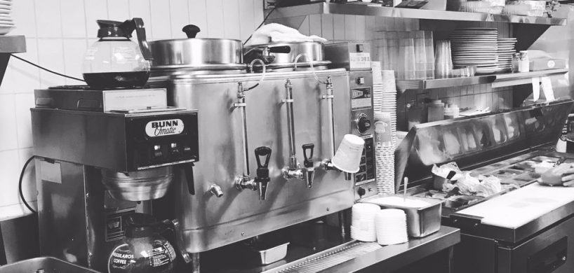This picture to pics Johny’s’s coffee machine and coffee station in a black-and-white photo which expresses the originality of this establishment