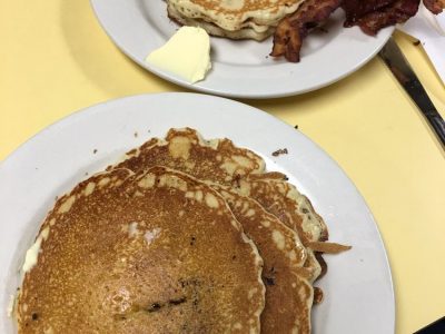 pancakes. This picture indicates an idea of what the pancakes and Johnys Luncheonette look like when you eat it in. It is a picture two orders of pancakes on Johny’s yellow counter